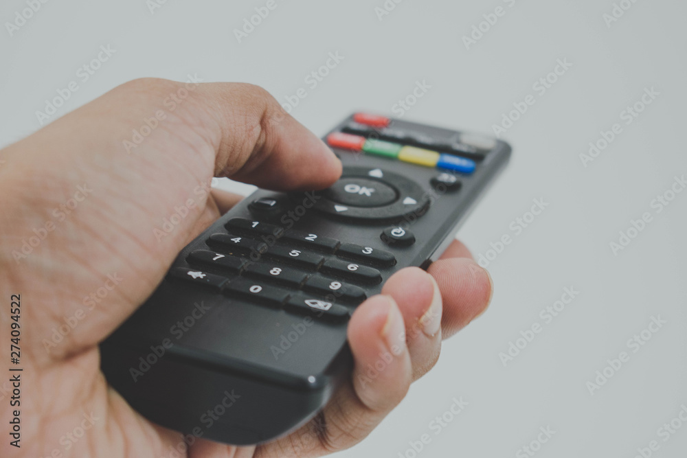 hand holding remote control isolated on white hand holding remote control isolated on white