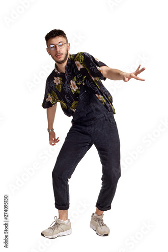 Full-length portrait of a funny guy dancing in studio isolated on white background. © nazarovsergey