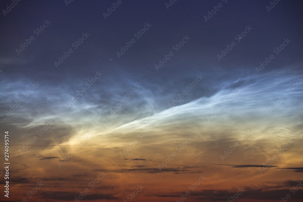 Noctilucent clouds closeup summer night.