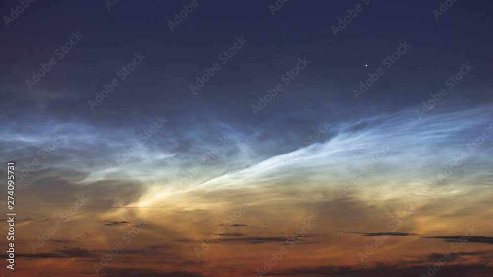 Noctilucent clouds closeup summer night.