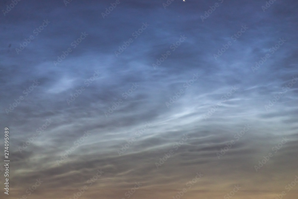 Noctilucent clouds closeup summer night. Noctilucent clouds closeup summer night.