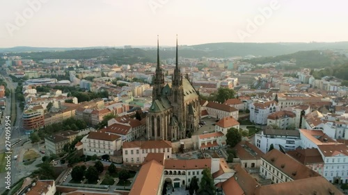 Europe, Czech Republic, Brno Cityscape with Landmarks, Cathedral of St. Peter And St. Paul. Aerial View of Old Town with Medieval Gothic Church on Petrov Hill at Sunset. 4K Zoom Quadcopter Shot photo