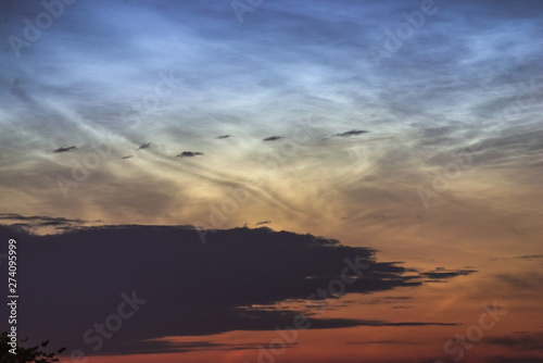 Noctilucent clouds closeup summer night.