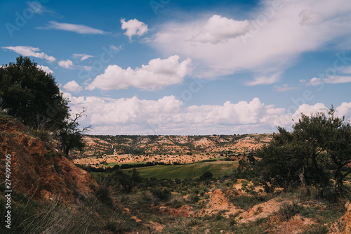 Landscape of nature. Rural area in Spain. Beautiful meadows with mountains and a beautiful blue sky with clouds. Panoramic background.