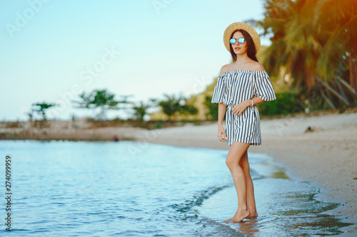 beautiful girl walking along the beach in thailand