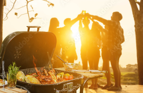 Group of six teenagers having fun on barbecue party
