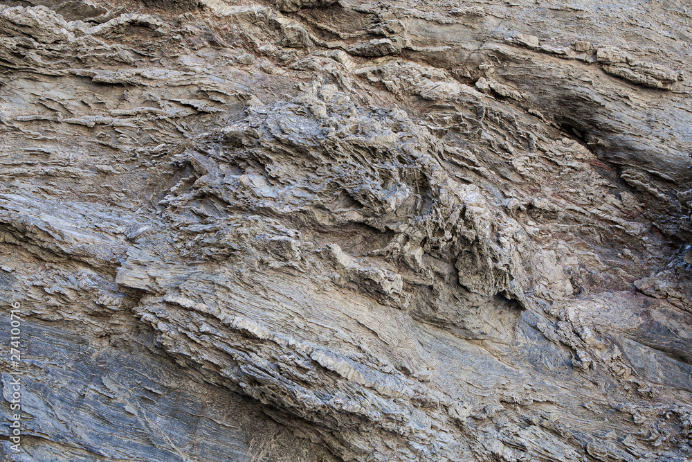 Textura de pedra natural. Superfície texturizada de rocha natural, onde se podem ver as linhas desenhadas na rocha ao longo do tempo. Pode ser usada como fundo. Textura de pedra natural. Superfície texturizada de rocha natural, onde se podem ver as linhas desenhadas na rocha ao longo do tempo. Pode ser usada como fundo.