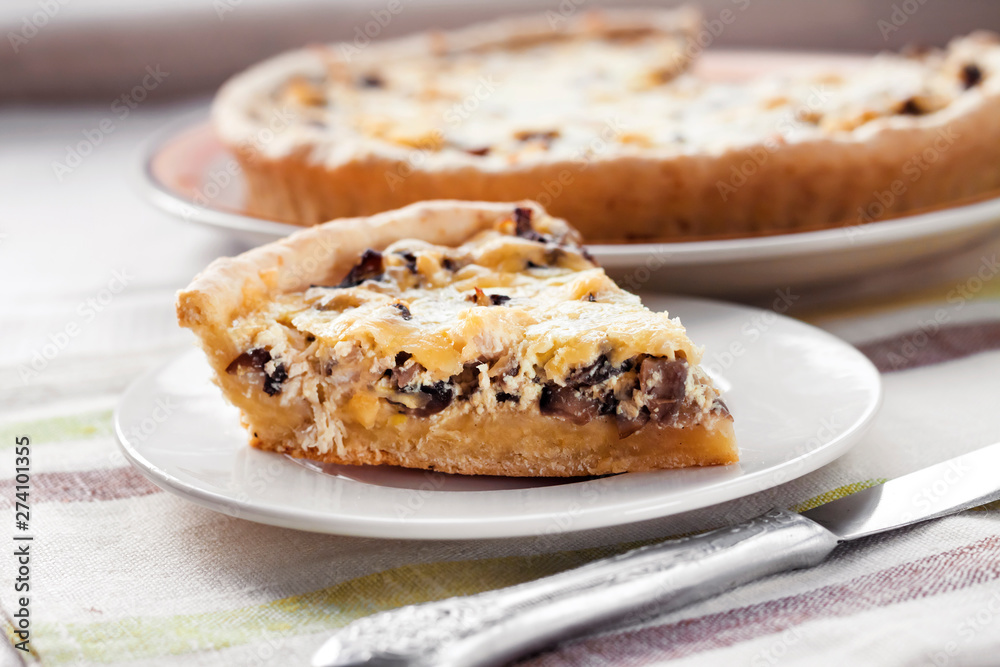 Slice of chicken tart with mushrooms and cheese on a plate Slice of chicken tart with mushrooms and cheese on a plate