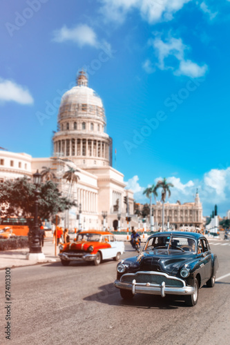 Classic  cars in downtown Havana next to the Capitol building © kmiragaya