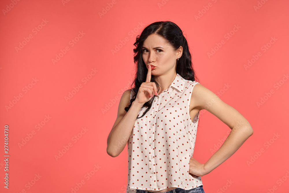 Studio shot of a beautiful girl teenager posing over a pink background. Studio shot of a beautiful girl teenager posing over a pink background.