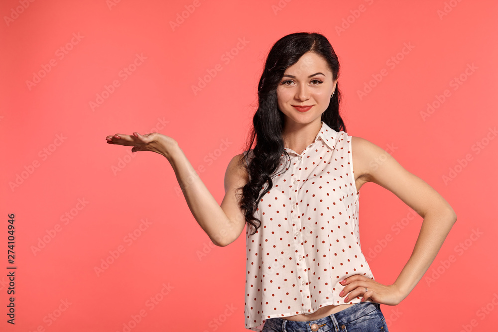 Studio shot of a beautiful girl teenager posing over a pink background. Studio shot of a beautiful girl teenager posing over a pink background.