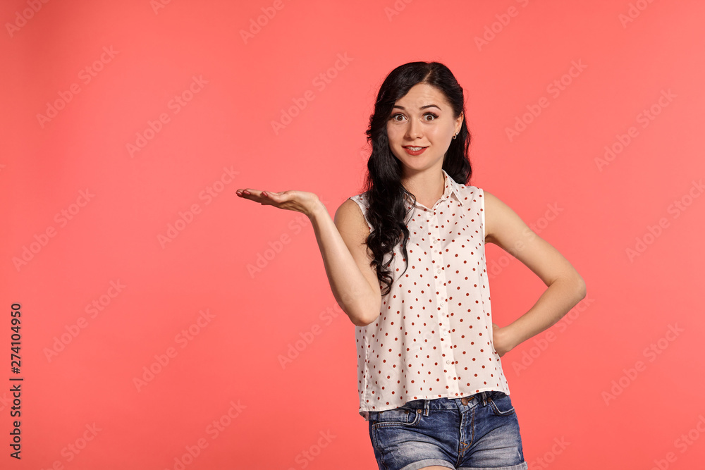 Studio shot of a beautiful girl teenager posing over a pink background. Studio shot of a beautiful girl teenager posing over a pink background.