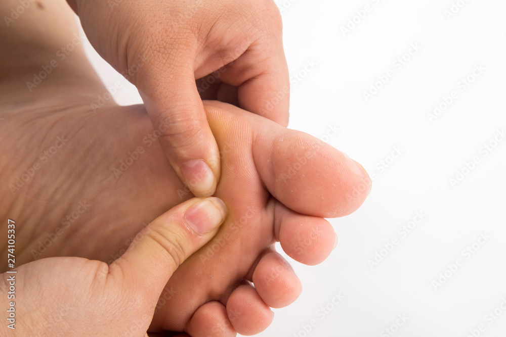 foot massage on white and isolated background foot massage on white and isolated background