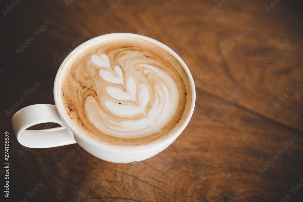 Cup of coffee latte on wood table in coffee shop cafe Cup of coffee latte on wood table in coffee shop cafe