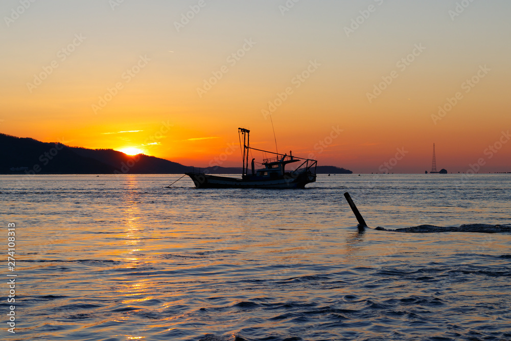 Anchored sea fishing boat.  sunset and fishing boat.