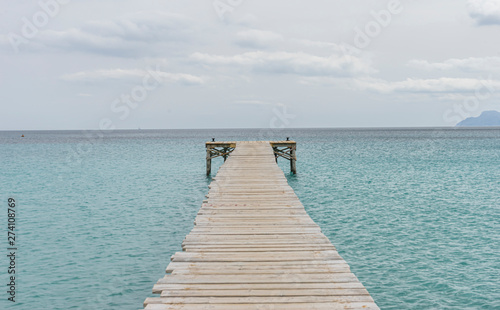 Wooden pier  calm turquoise waters in the Mediterranean Sea  holiday scenes with a sense of calm
