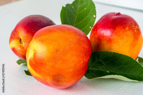 one fresh tasty peach on a white background