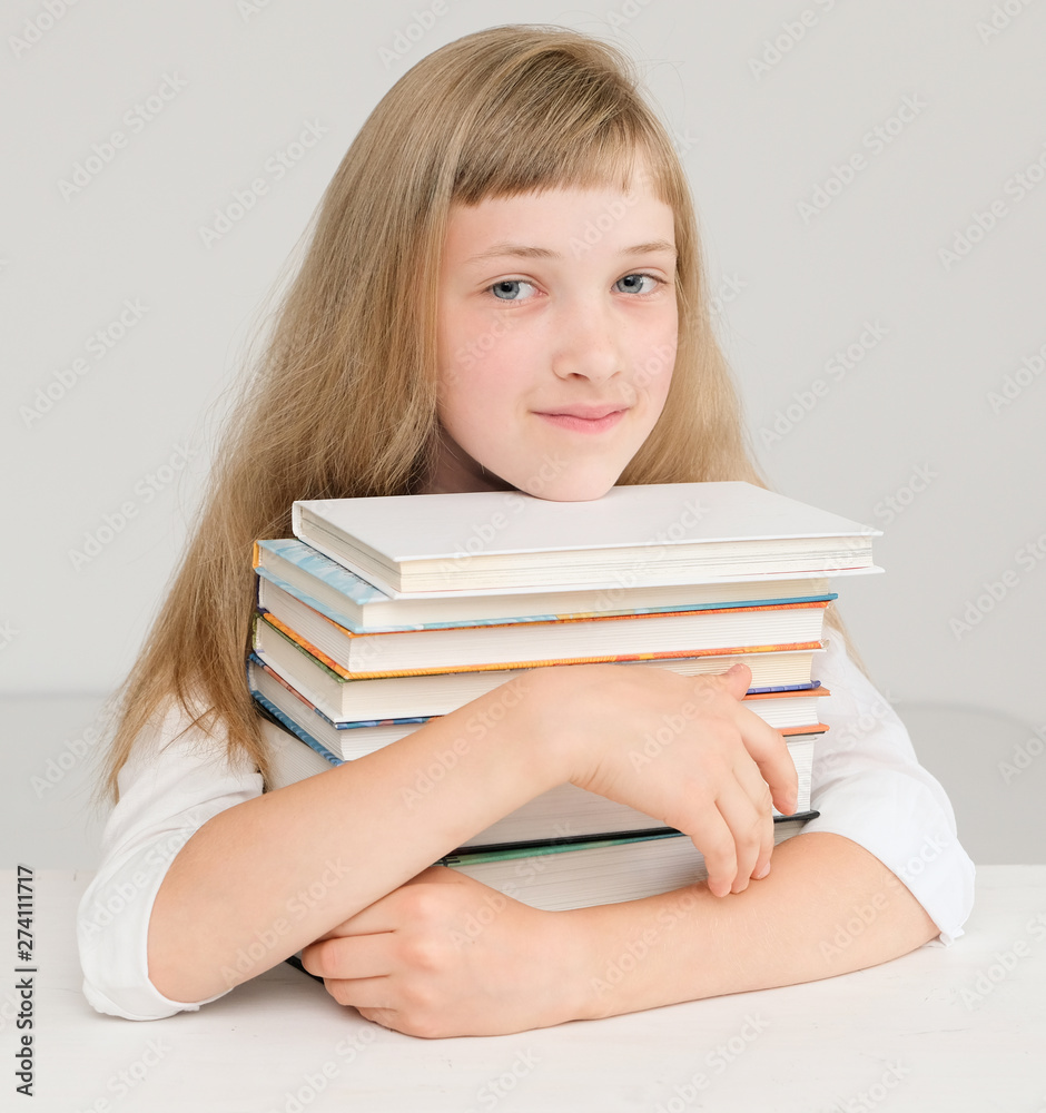 Cute girl with a stack of books; Cute girl with a stack of books;