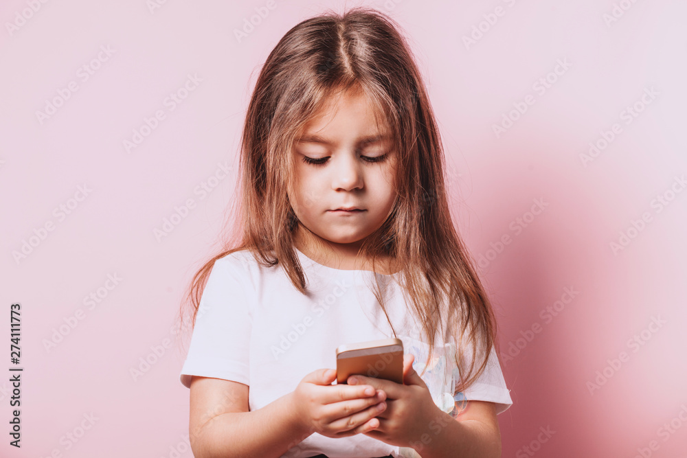 Happy little girl talking on telephone on pink background. Happy little girl talking on telephone on pink background.