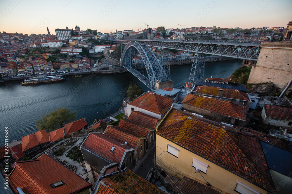 View of the Luis I Iron bridge over the Douro river at dusk, Porto, Portugal.