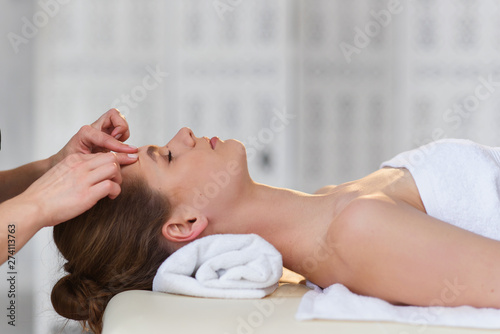 Relaxing caucasian woman during massage in the spa salon.