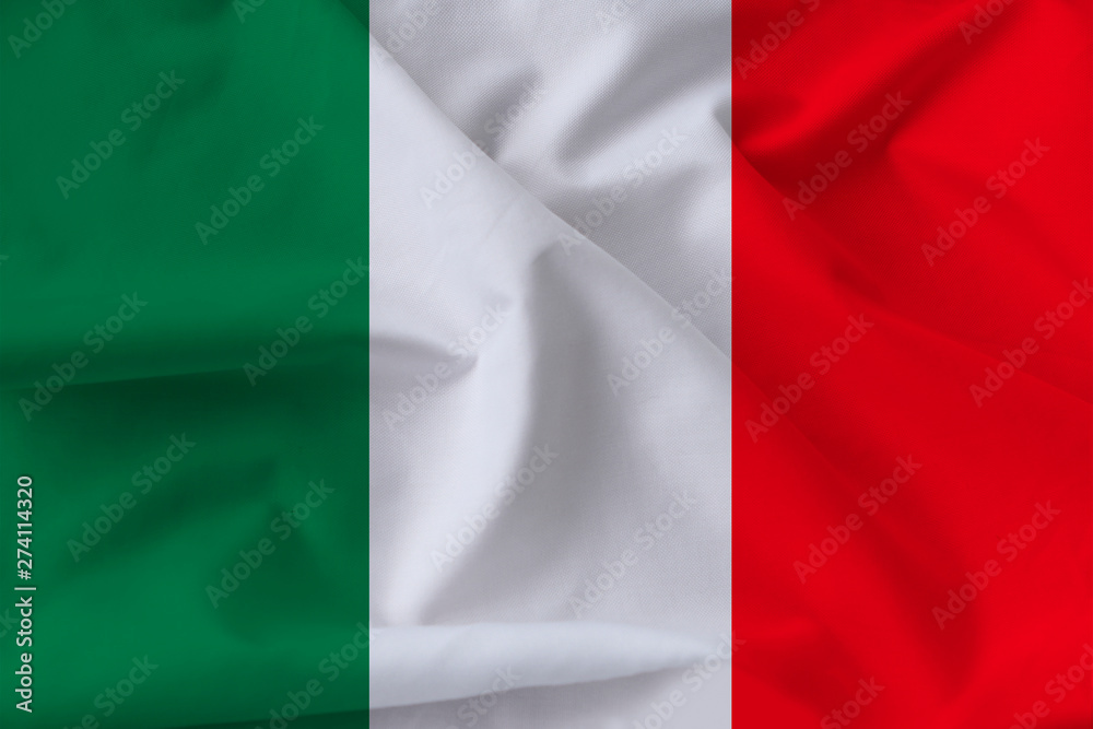 beautiful national flag of Italy on soft silk with soft folds in the wind, close-up, copy space