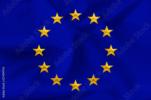 beautiful national flag of the European Union on soft silk with soft folds close-up on the background, the concept of unity, cooperation, international union