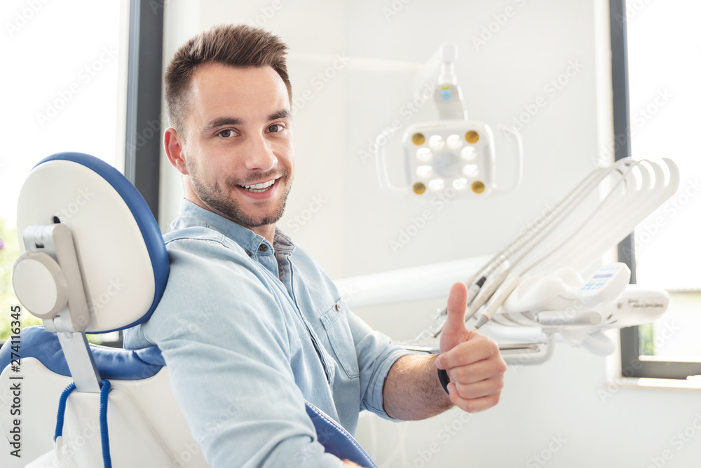 © Proxima Studio - Man showing thumbs up at the dental clinic © Proxima Studio - Man showing thumbs up at the dental clinic
