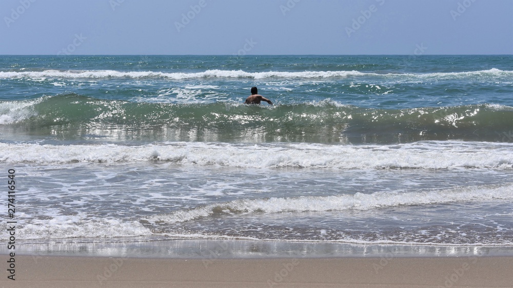 Bather entering the sea between the waves Bather entering the sea between the waves