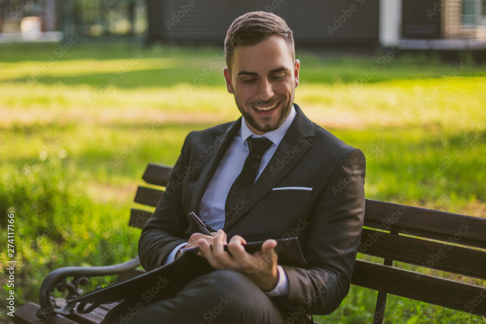 Fototapeta premium Elegant businessman working outdoor.Toned photo.