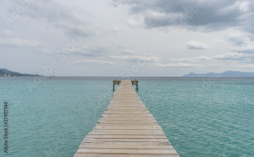 Wooden pier  calm turquoise waters in the Mediterranean Sea  holiday scenes with a sense of calm
