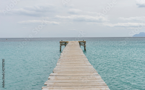 Wooden pier  calm turquoise waters in the Mediterranean Sea  holiday scenes with a sense of calm