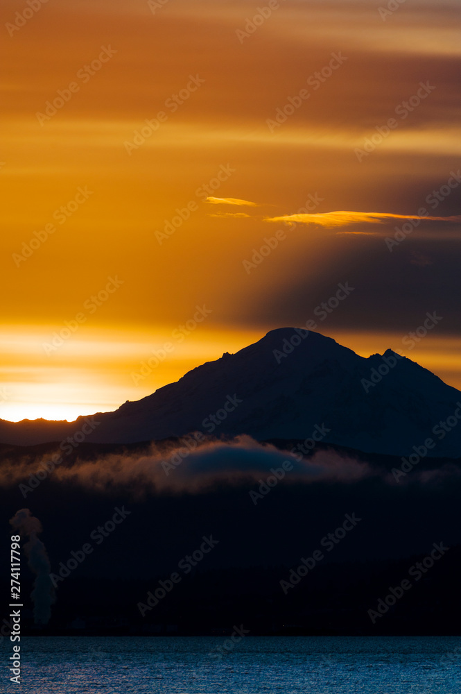 Dramatic Sunrise Over Mt. Baker and Bellingham Bay.  First light behind Mt. Baker, Washington, can be a dramatic and colorful event in the Pacific Northwest.