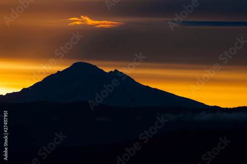 Dramatic Sunrise Over Mt. Baker and Bellingham Bay. First light behind Mt. Baker, Washington, can be a dramatic and colorful event in the Pacific Northwest.