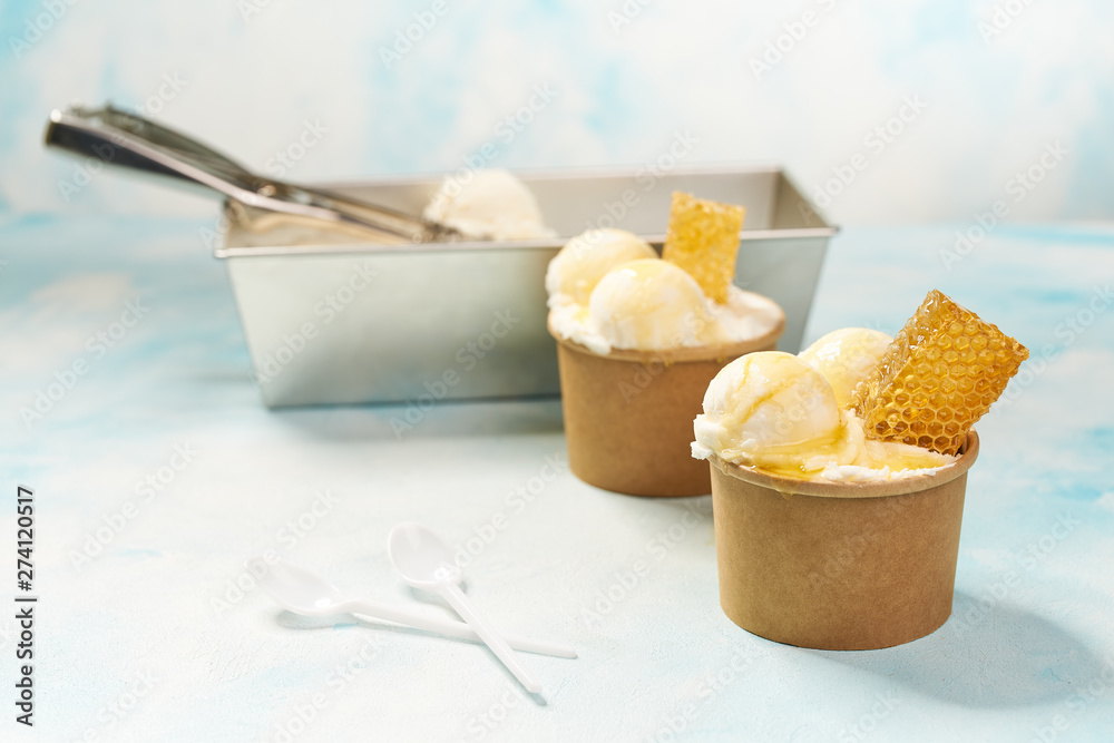 Spoon for ice cream takes a little out of the package vanilla ice cream. Making ball of ice