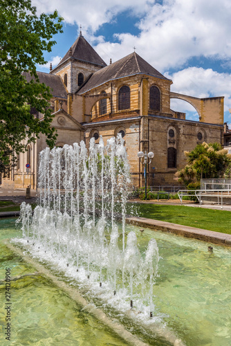 Cathedral Notre Dame in Dax town, as seen from the park, the fountain is at foreground. Southwestern France, Landes, Nouvelle Aquitaine. photo