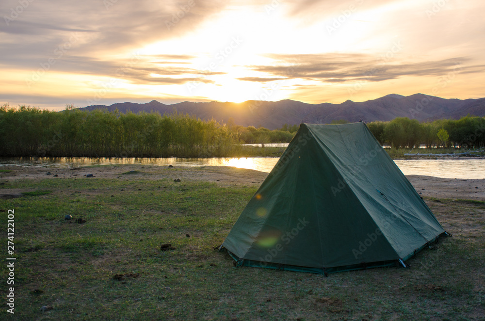 Camping and sunset behind the tent Camping and sunset behind the tent