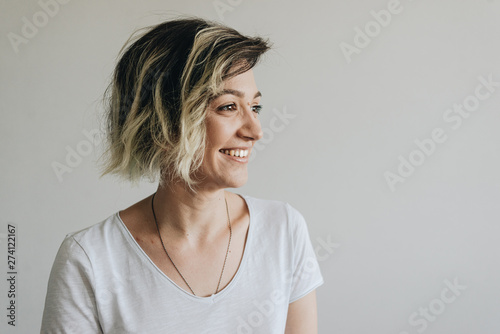 Beautiful young girl with short hair is smiling.
