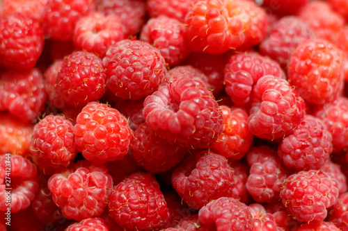 Heap of sweet red raspberries close up for background