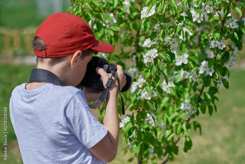 Boy using digital camera taking photo in the nature, hobbies concept – Image.