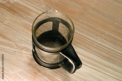 Empty coffee pot on wooden background