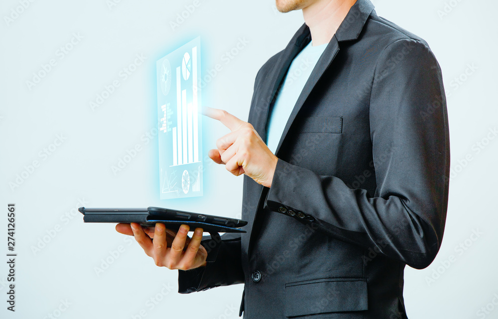 Businessman interacts with virtual screen, analyze data. Innovation Graphs Interfaces. Businessman interacts with virtual screen, analyze data. Innovation Graphs Interfaces.