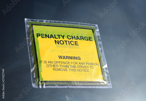 Close up of a parking penalty notice attached to a car windscreen. Known also as a PCN or Parking Charge Notice or Parking Ticket. 