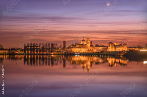 UNESCO World Heritage site Mantua city illuminated after the sunset with reflections on the lake © SirDiegoSama