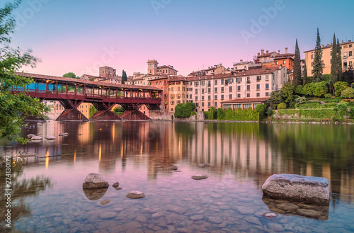 Bassano del Grappa during the sunset with city reflections on Brenta River photo
