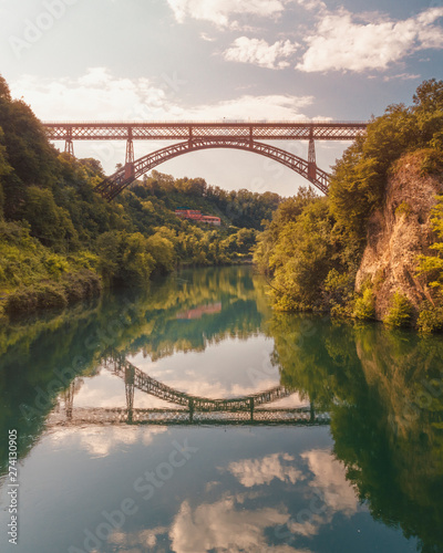 San Michele bridge over Adda with reflections