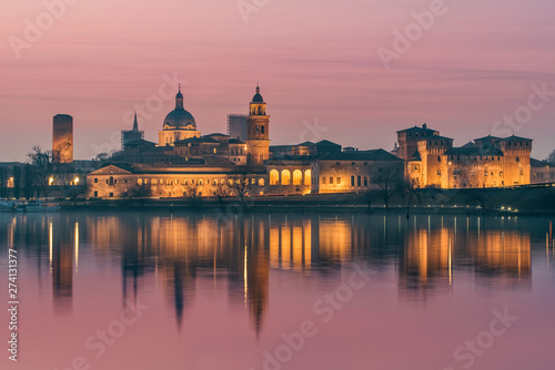 UNESCO World Heritage site Mantua city with pink sky at sunset with city reflections on the Mincio River