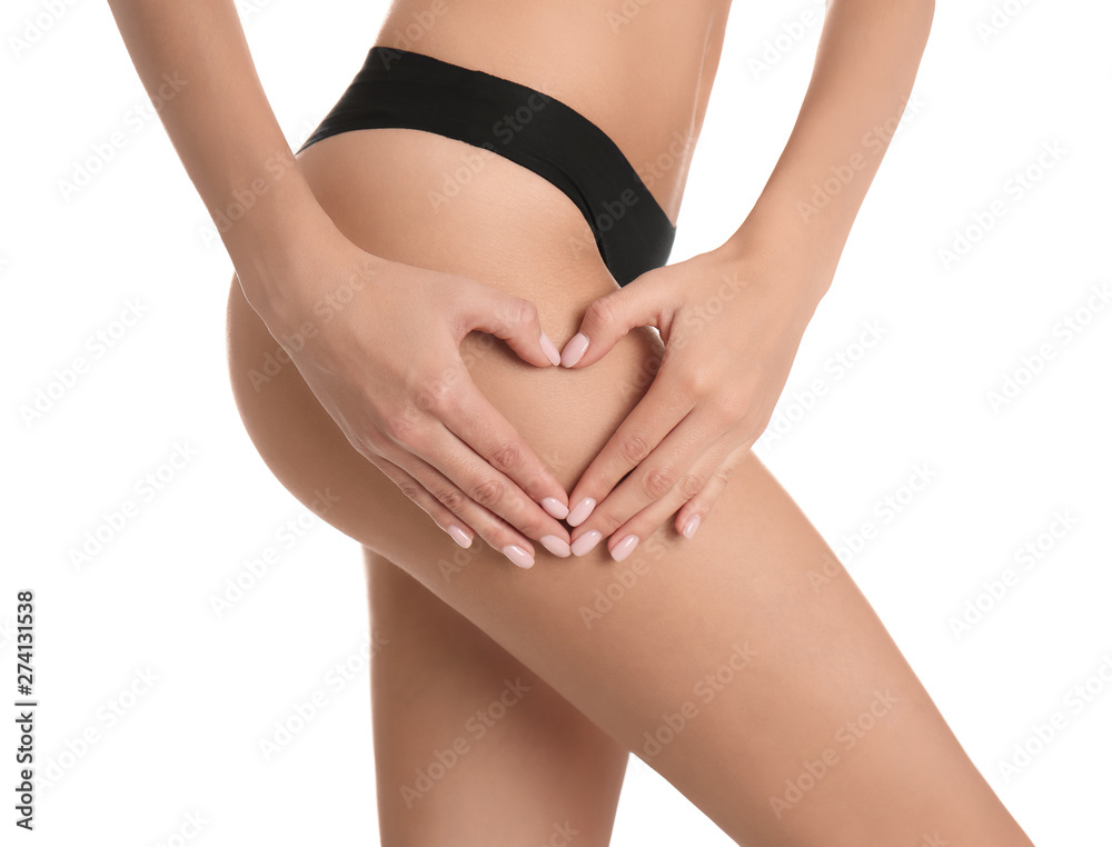 Closeup view of slim woman in underwear making heart with hands near thigh on white background. Cellulite problem concept