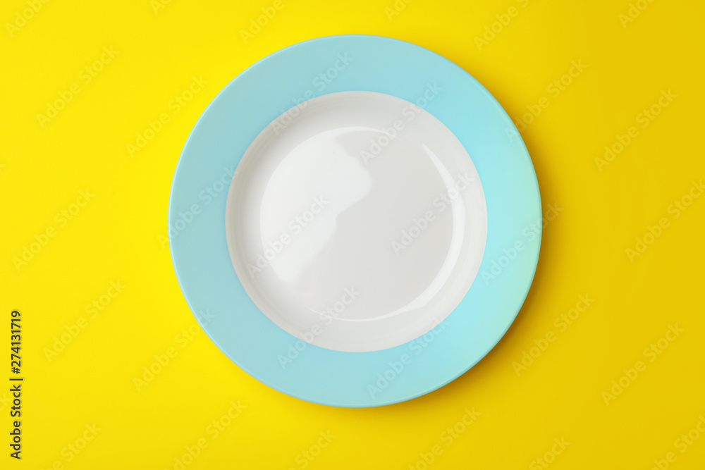Clean empty plate on color background, top view Clean empty plate on color background, top view