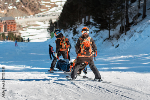 Rescuers at a ski resort evacuate the victim from the slope. photo